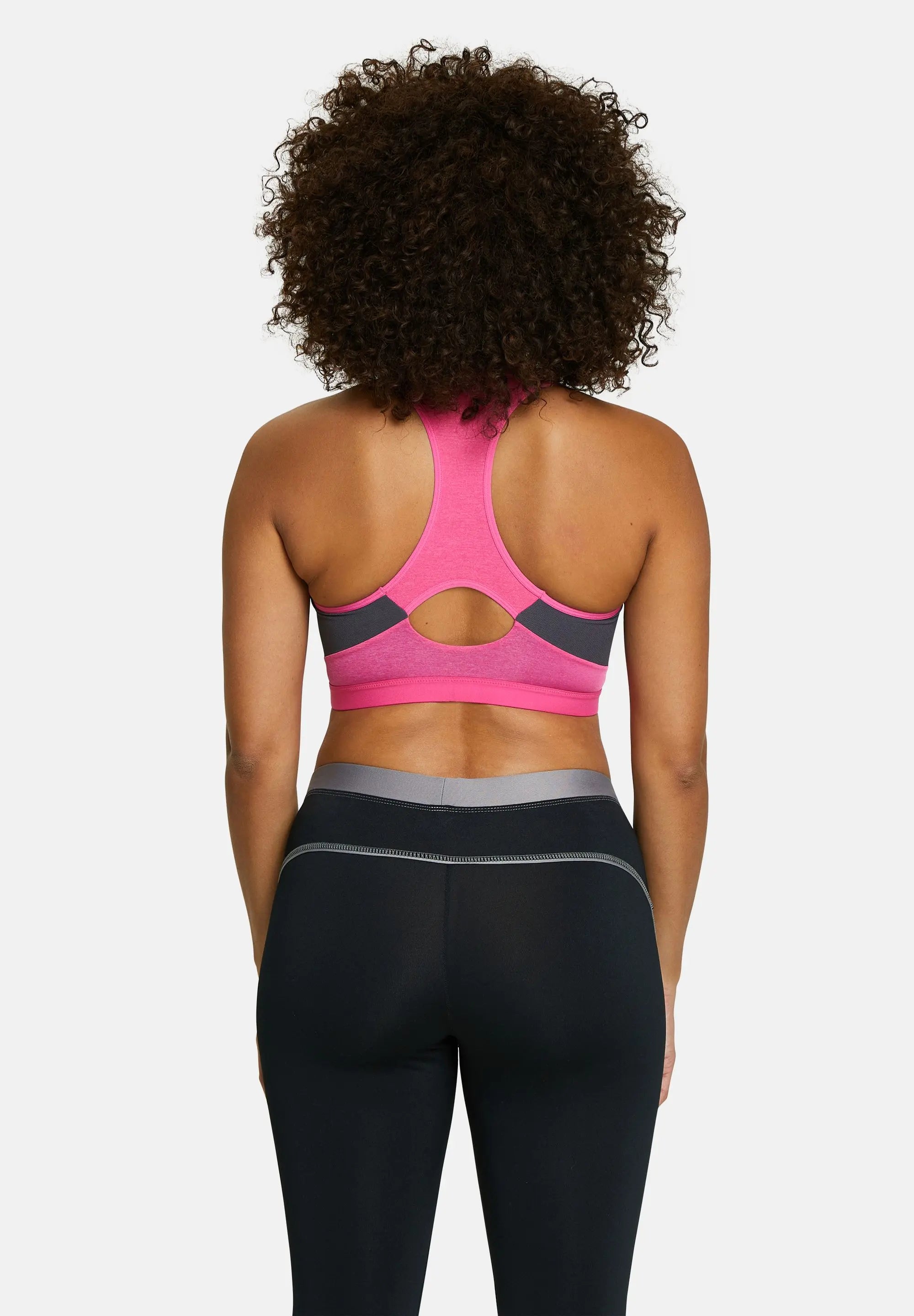 Brassière de sport pour femme couleur fushia - portée par une modèle de dos